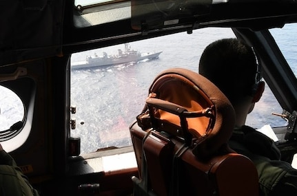 The Japan Maritime Self-Defense Force (JMSDF) Murasame-class destroyer JS Inazuma (DD-105) is seen from the cockpit of a JMSDF UP-3D aircraft during their Fujin bilateral training exercise with the U.S. Navy's expeditionary Electronic Attack Squadron (VAQ) 131.