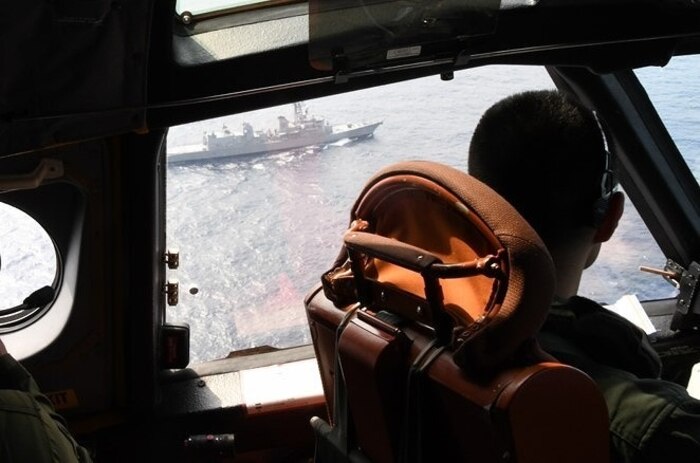 The Japan Maritime Self-Defense Force (JMSDF) Murasame-class destroyer JS Inazuma (DD-105) is seen from the cockpit of a JMSDF UP-3D aircraft during their Fujin bilateral training exercise with the U.S. Navy's expeditionary Electronic Attack Squadron (VAQ) 131.
