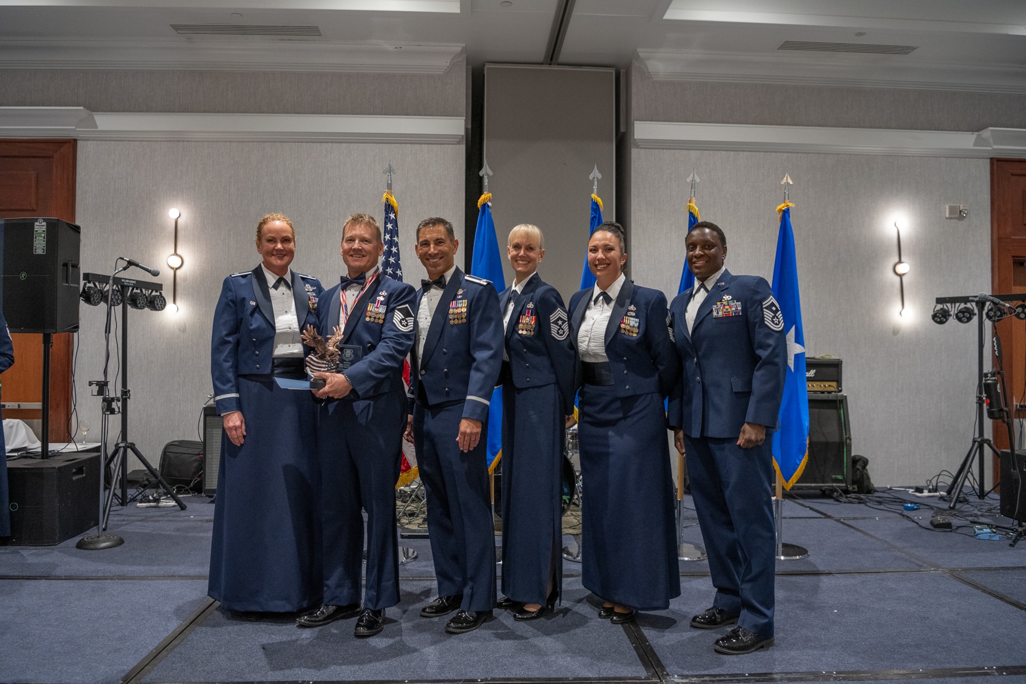 A row of servicemembers standing together on stage.