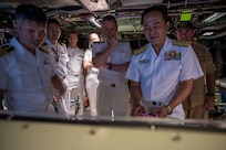 JOINT BASE PEARL HARBOR-HICKAM (April 4, 2025) — Japan Maritime Self-Defense Force Vice Adm. Nobuyuki Takenaka, commander, Fleet Submarine Force, right, and Royal Navy Rear Adm. Andrew Perks, director submarines, center, tour the Virginia-class fast-attack submarine USS Montana (SSN 794) during the Undersea Warfare Commanders’ Conference (USWCC) on Joint Base Pearl Harbor-Hickam, April 4, 2025. First held in 2018, this year’s theme was “Strengthening Theater Undersea Warfare Interoperability and Lethality in the Indo-Pacific Theater.” The USWCC conference included submarine force representatives from Australia, Canada, France, Japan, Republic of Korea, Singapore, and the U.K. The multi-day event included briefings from each partner nation focused on force employment, combat readiness, interoperability, and integration of emerging technology such as unmanned systems and artificial intelligence. (U.S. Navy photo by Mass Communication Specialist 1st Class Scott Barnes)