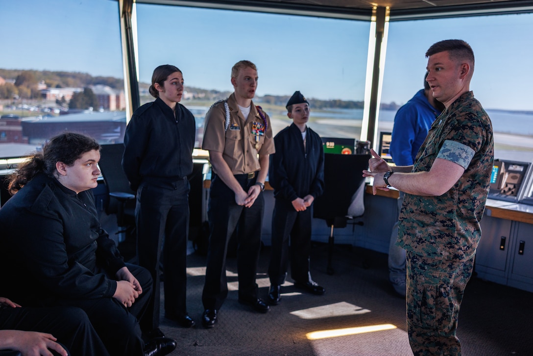 U.S. Marine Corps Staff Sgt. Jonathan Birkeland, an air traffic controller with Marine Corps Air Facility Quantico, briefs cadets from Brooke Point High School and Highland High School Navy Junior Reserve Officer Training Corps at MCAF on Marine Corps Base Quantico, Virginia, April 9, 2025. Cadets receive demonstrations on basic operations and procedures at MCAF Quantico, including expeditionary fire and emergency service, air control towers, military working dogs, and flight operations. (U.S. Marine Corps photo by Lance Cpl. Braydon Rogers)