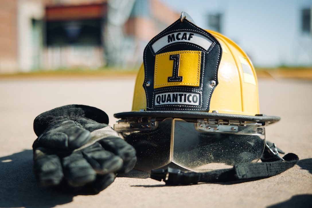 A Marine Corps Air Facility Quantico Expeditionary Fire and Emergency Services helmet and gloves are on display during a Navy Junior Officer Training Corps event at MCAF on Marine Corps Base Quantico, Virginia, April 9, 2025. Cadets receive demonstrations on basic operations and procedures at MCAF Quantico, including expeditionary fire and emergency service, air control towers, military working dogs, and flight operations. (U.S. Marine Corps photo by Lance Cpl. Braydon Rogers)