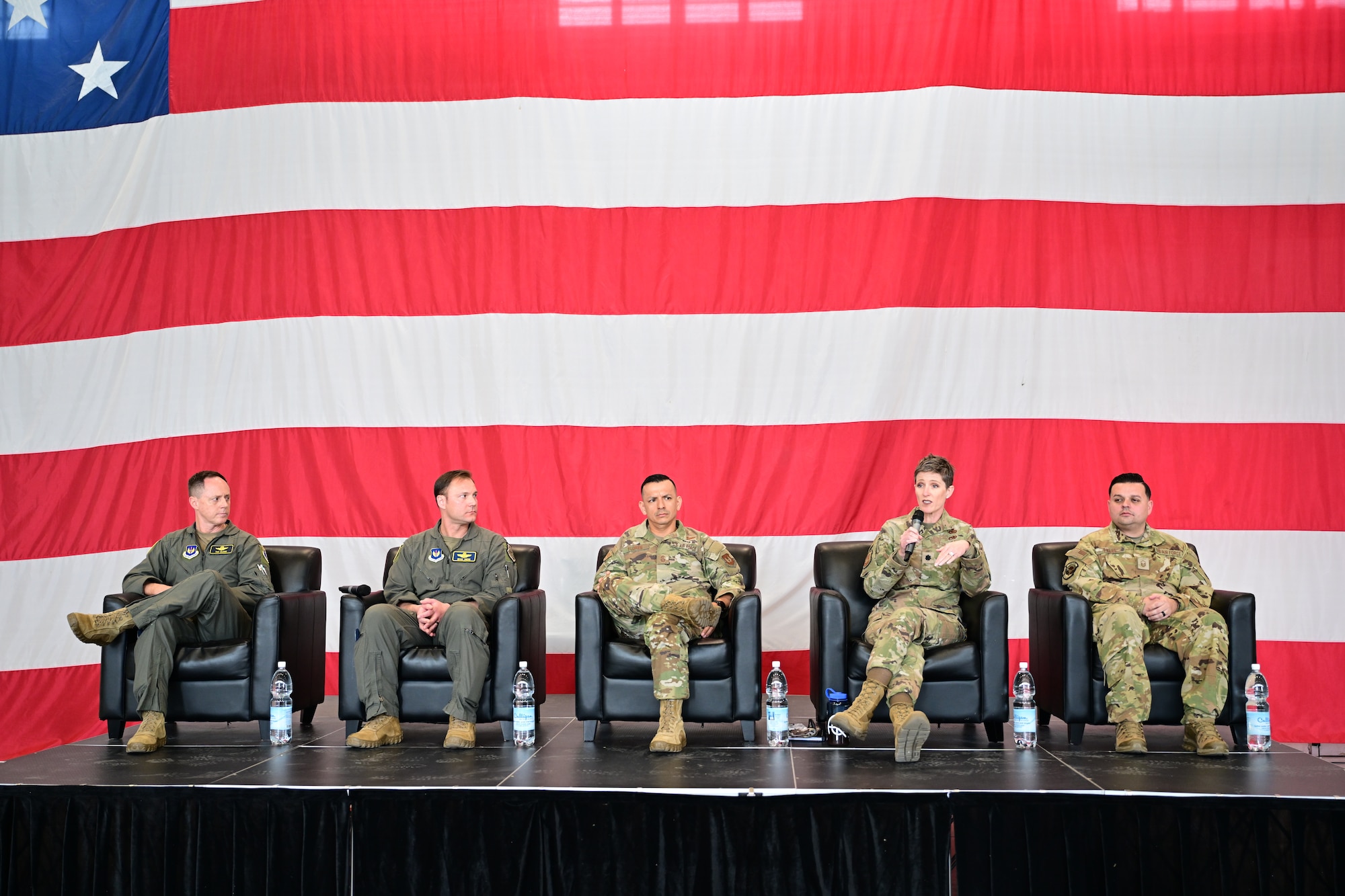 5 individuals part of the 31st Fighter Wing leadership team, sit on stage as a panel to speak to Airmen.