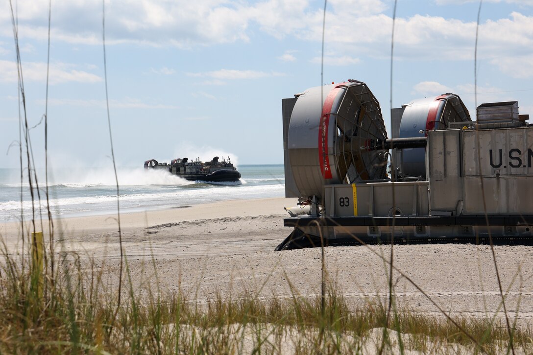 A U.S. Navy Landing Craft Air Cushion (LCAC), of Iwo Jima Amphibious Ready Group (IWOARG), lands on Onslow Beach, North Carolina, on April 8, 2025, to conduct off-load operations in support of Amphibious Squadron 8 (PHIBRON 8), 22nd MEU Integration (PMINT). PMINT is the 22nd MEU’s first opportunity in their pre-deployment training program to fully integrate with PHIBRON 8 while at sea, allowing Marines and Sailors to train together as an ARG/MEU team. (U.S. Marine Corps photo by Cpl. Sharon Ruiz)