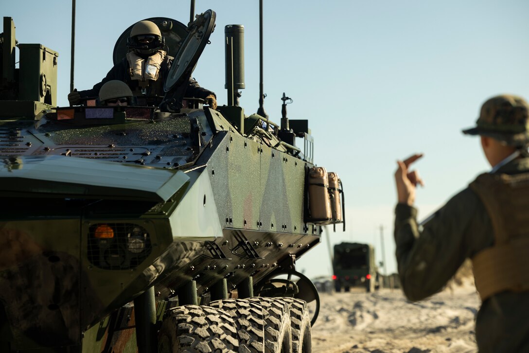 A U.S Marine with 2d Assault Amphibian Battalion, 2d Marine Division, ground guides an amphibious combat vehicle on Marine Corps Base Camp Lejeune, North Carolina, March 27, 2025. U.S. Marines and contractors conducted a variety of tests on the aspects and functionalities of the ACV. (U.S. Marine Corps photo by Lance Cpl. Alexandria Serrano)