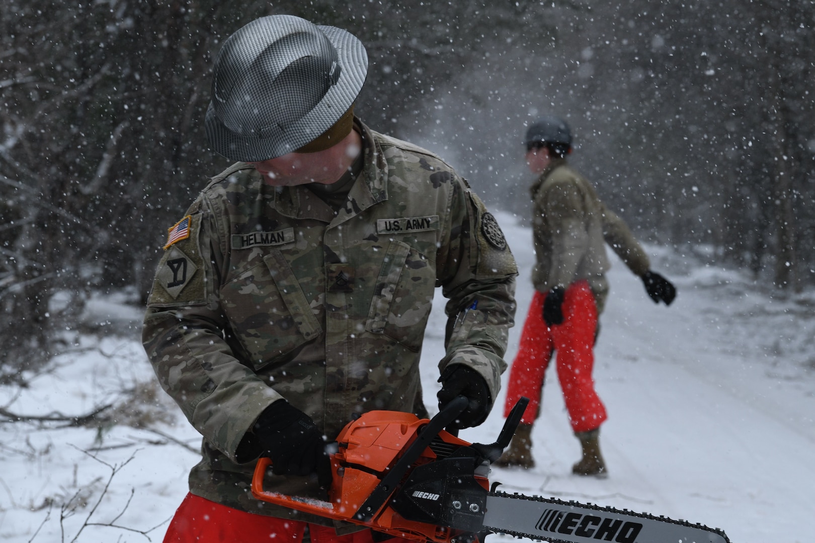 U.S. Army Staff Sgt. Gary Hellman, assigned to the 1434th Engineer Company, clears large trees from roadways on Beaver Island, Michigan, April 9, 2025.