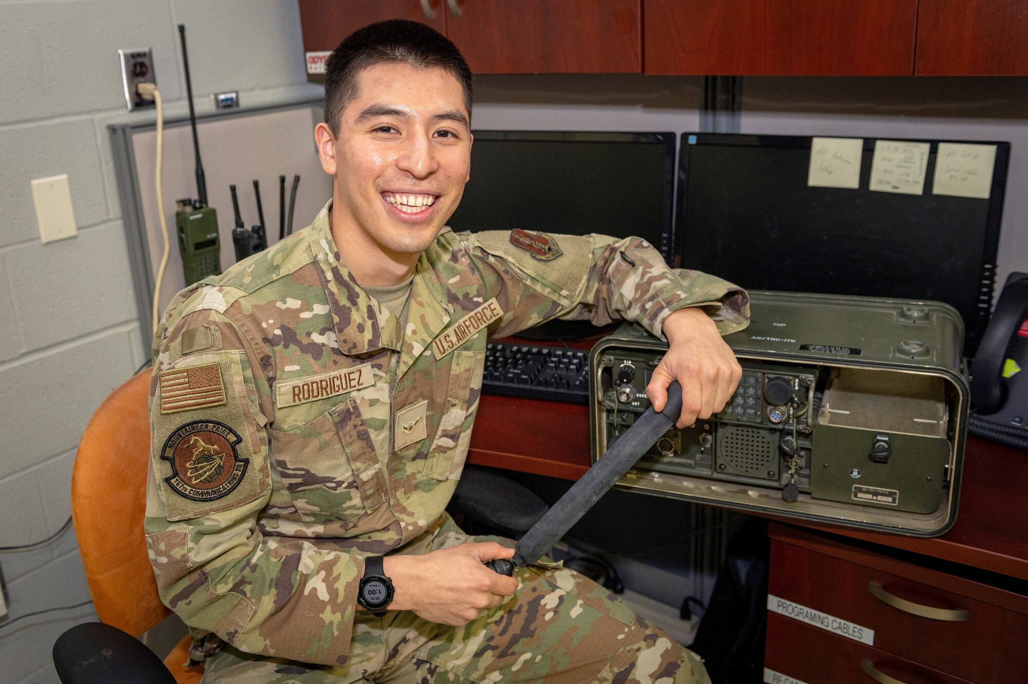 a man in uniform sits by a desk