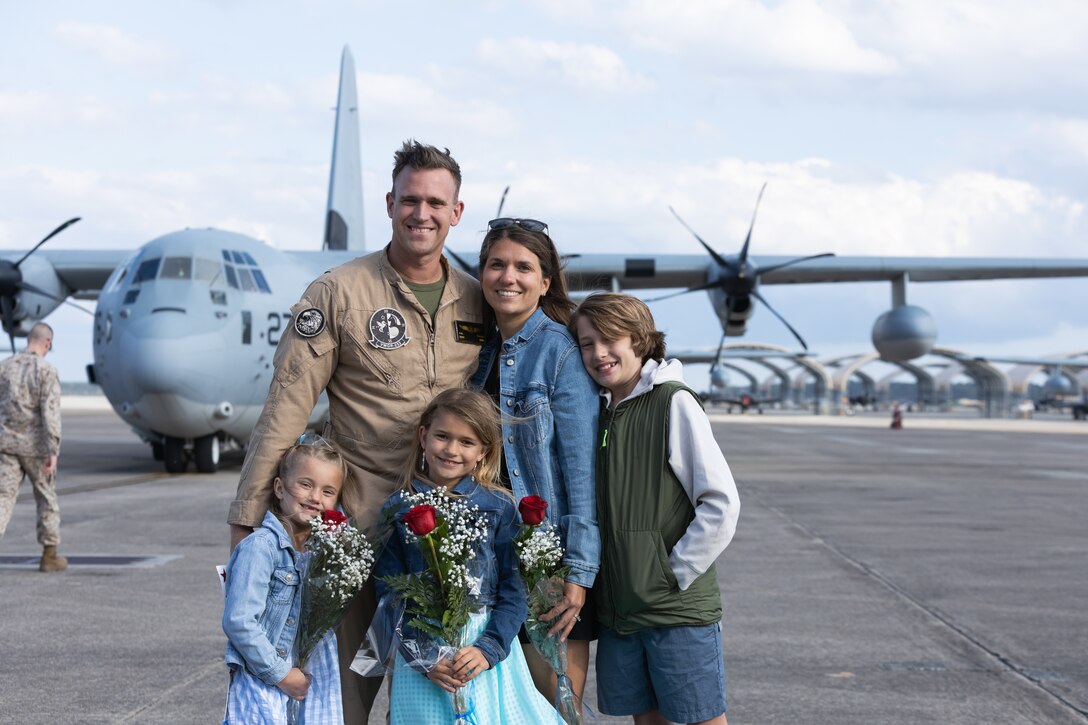 U.S. Marine Corps Master Sgt. Brandon Paulsen, from Illinois, a KC-130 loadmaster with Marine Aerial Refueler Transport Squadron (VMGR) 252, poses for a picture with his family at Marine Corps Air Station Cherry Point, North Carolina, April 8, 2025. VMGR-252 returned home from a five-month deployment in support of Combined Joint Task Force - Horn of Africa. (U.S. Marine Corps photo by Pfc. Gavin Kulczewski)