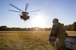 A photo of a helicopter flying in approach to a U.S. Marine.