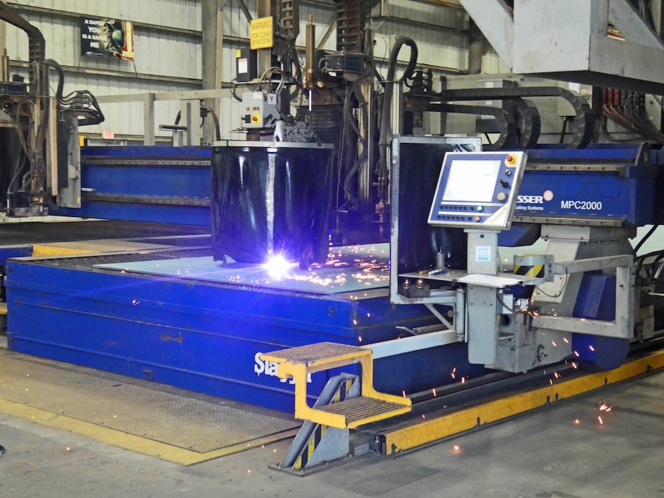 The U.S. Army Corps of Engineers joined contractors Eastern Shipbuilding Group and Royal IHC on April 4, 2025, in Panama City, FL for a steel cutting ceremony, kicking off construction of a Medium Class Hopper Dredge to replace the Dredge McFARLAND of the Army Corps’ Philadelphia District. The first cuts were made by a CNC Plasma Arc Burning Machine on an 8’ x 50’ x 5/8” sheet of ABS-14 raw steel plate.