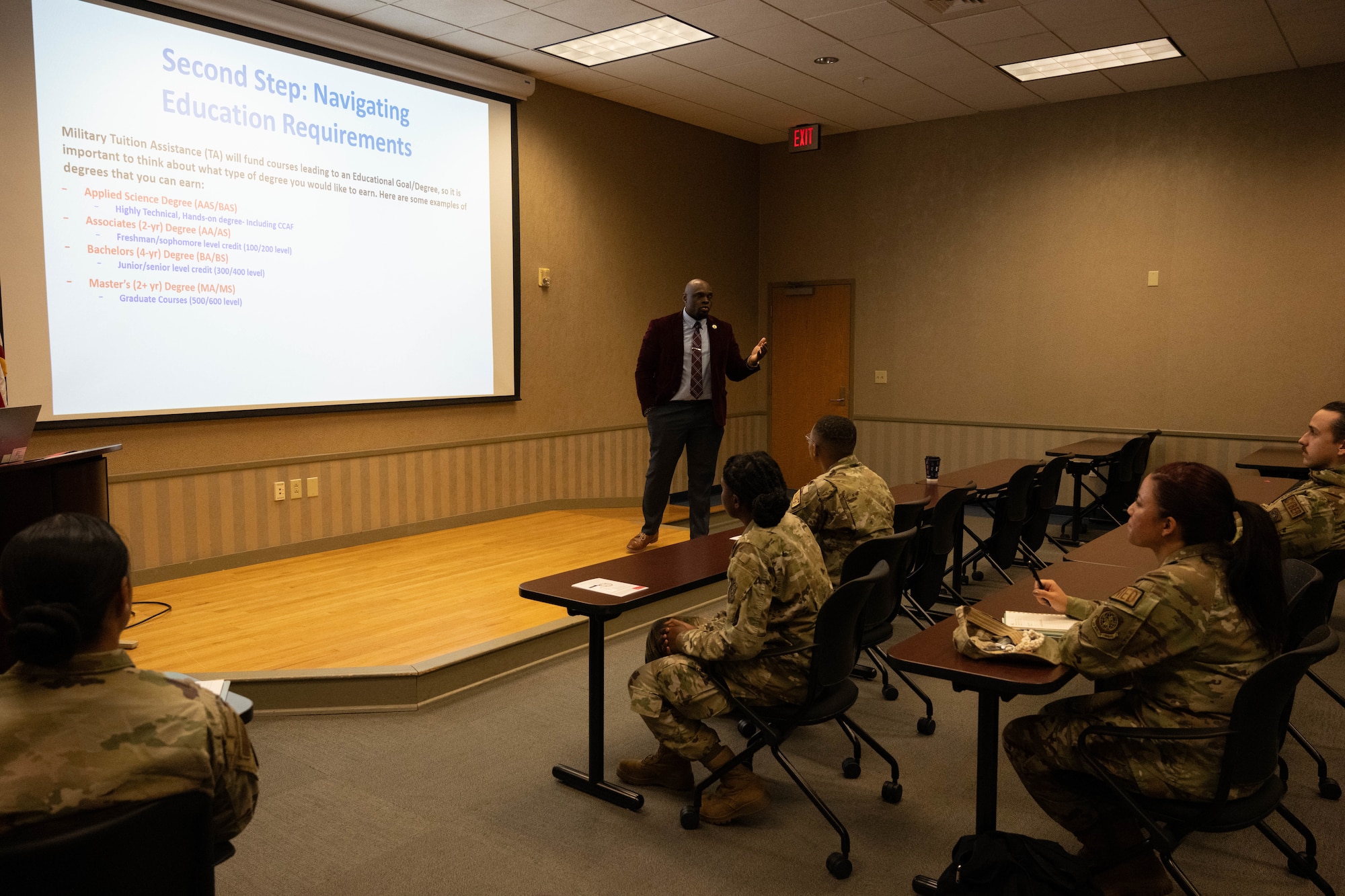 A man speak to a crowd of Airmen.