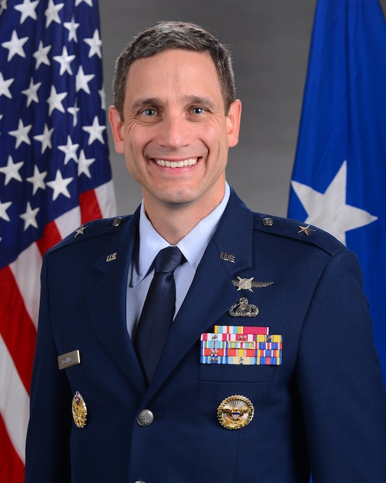 A military member stands for a portrait.