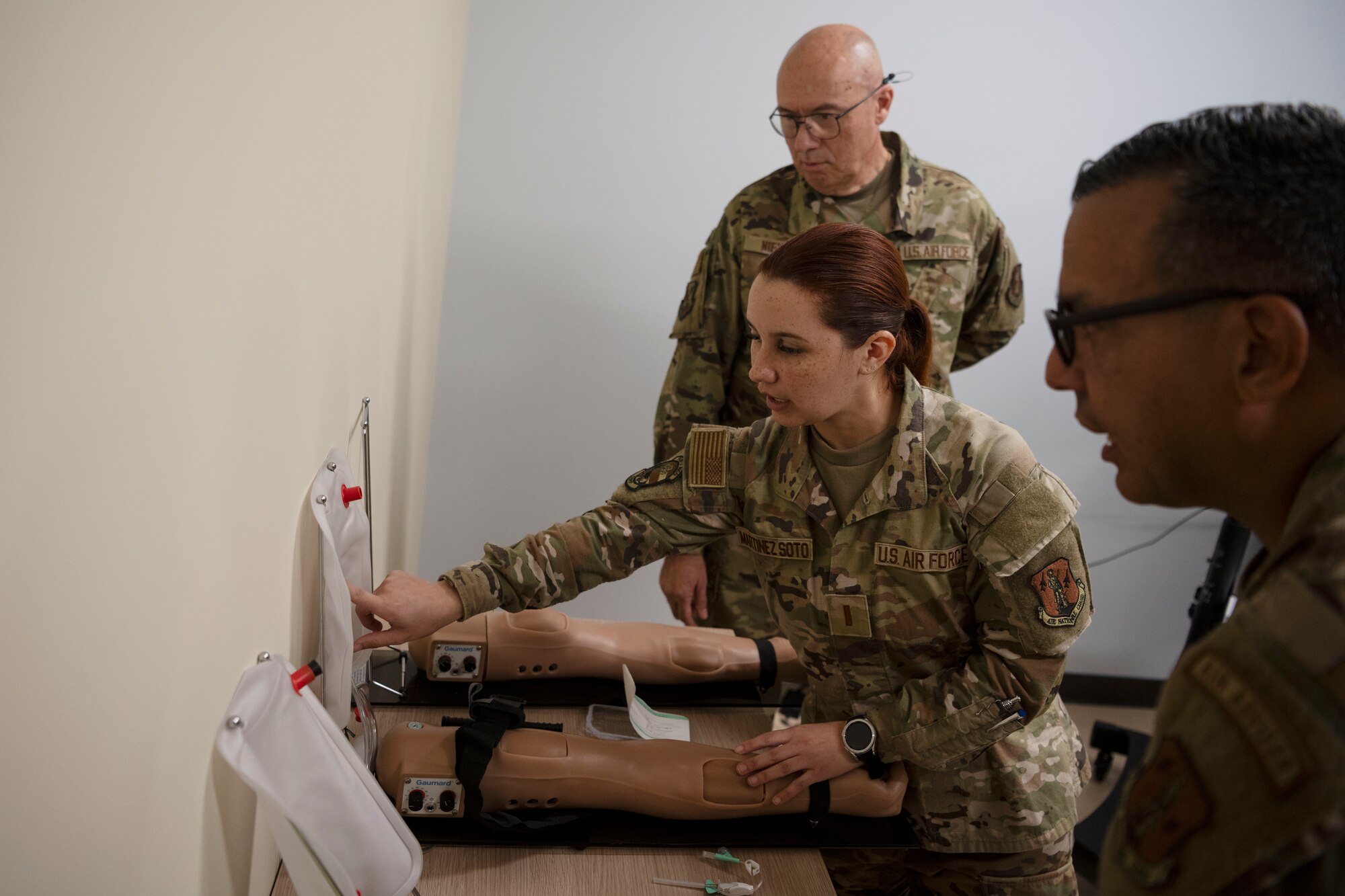 U.S. Air Force 2nd Lt. Adliana Martinez, clinical nurse, 156th Medical Group, Detachment 1, Puerto Rico Air National Guard, showcases a blood drawing training station during the medical group trauma training simulator lab inauguration at Muñiz Air National Guard Base, Carolina, Puerto Rico, April 6, 2025. The inauguration was conducted by demonstrating the lab's capabilities to 156th Wing leadership and Puerto Rico state guard air members as part of the third phase of a five-phase medical modernization project valued at approximately $160k. (U.S. Air National Guard photo by Master Sgt. Rafael D. Rosa)