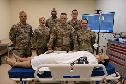 U.S. Airmen assigned to the 156th Medical Group, Detachment 1, Puerto Rico Air National Guard, pose for a group photo during the medical group trauma training simulator lab inauguration at Muñiz Air National Guard Base, Carolina, Puerto Rico, April 6, 2025.