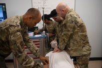 U.S. Airmen assigned to the 156th Medical Group, Detachment 1, Puerto Rico Air National Guard, respond to an emergency scenario with the SimMan 3G Plus mannequin during the medical group trauma training simulator lab inauguration at Muñiz Air National Guard Base, Carolina, Puerto Rico, April 6, 2025.
