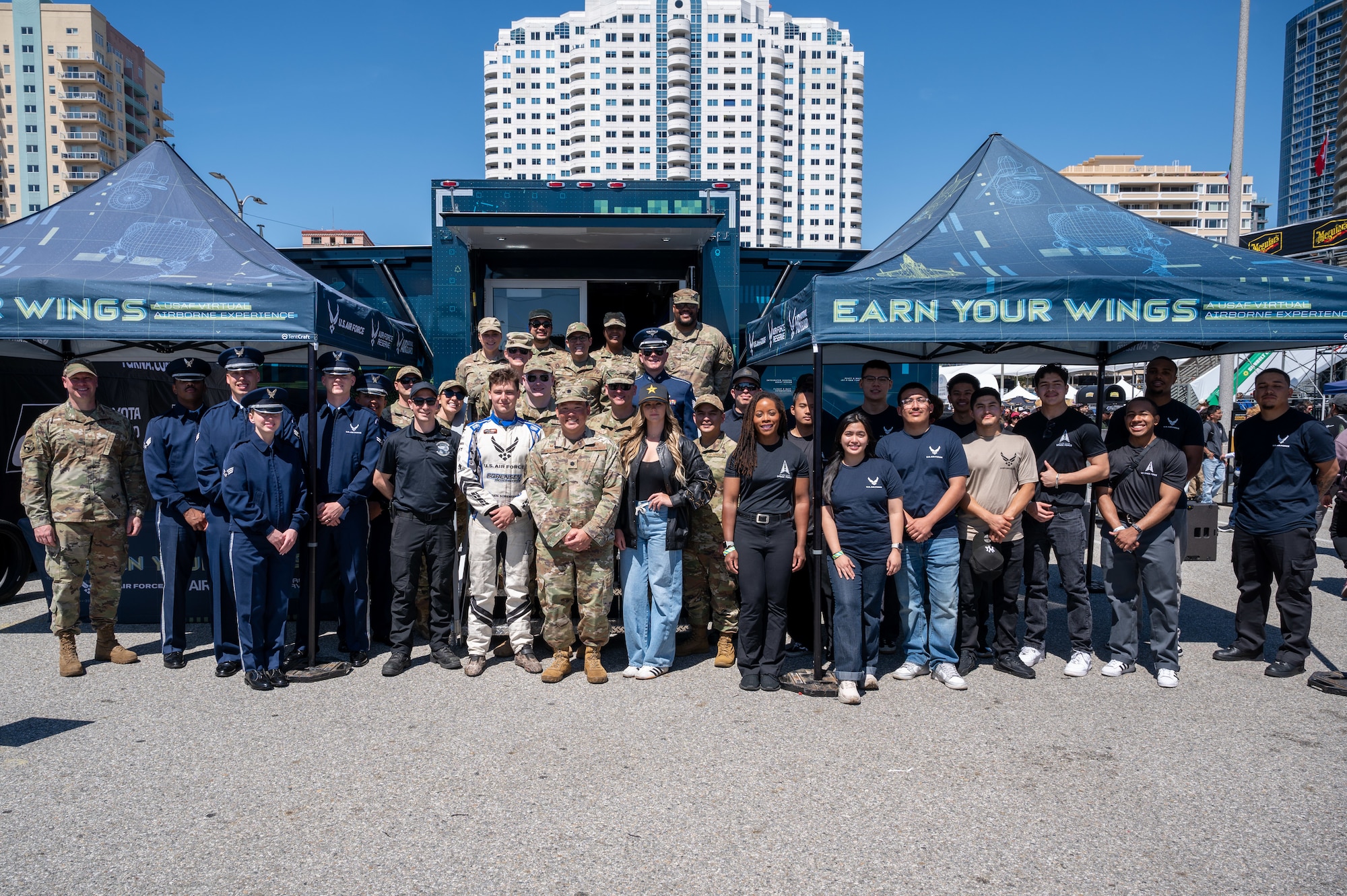 U.S. Air Force Lt. Col Tyler K. Awakuni, the 369th Recruiting Squadron commander, Amanda and Branden Sorensen, Air Force Recruiting Service-sponsored motorsports athletes, members of The U.S. Air Force Band’s Max Impact, Air Force recruiters, delayed entry program recruits and members of the Edwards Air Force Base Honor Guard gather during a Formula Drift event, Long Beach, Calif., April 5, 2025. Max Impact partnered with Air Force Recruiting Service to perform and sing the national anthem at the event. Max Impact consists of six active-duty musicians stationed at Joint Base Anacostia-Bolling, Washington, D.C. (U.S. Air Force photo by Hayden Hallman)