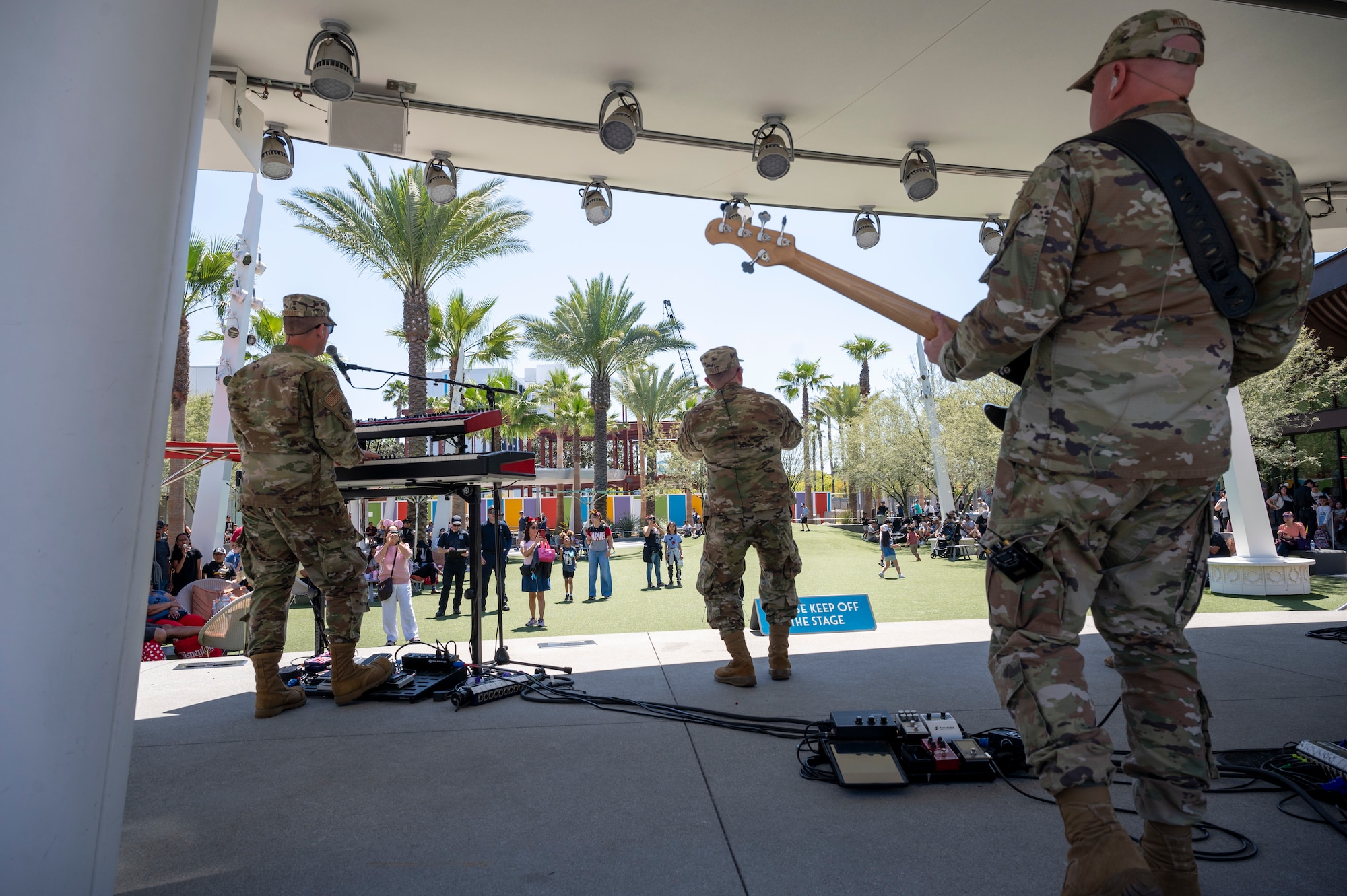 From left, U.S. Air Force Tech. Sgt. Aaron Trasatt, keyboardist, Tech. Sgt. Benton Felty, a vocalist, and Master Sgt. Mike Wittrien, the noncommissioned officer in charge and bassist, all with The U.S. Air Force Band's Max Impact, perform during the Southern California tour at the Downtown Disney District, Anaheim, Calif., April 6, 2025. The mission of Max Impact, a rock band, is to honor those who have served, inspire American citizens to heightened patriotism and service, and connect the global community on behalf of the Air Force and the United States. Max Impact consists of six active-duty musicians stationed at Joint Base Anacostia-Bolling, Washington, D.C. (U.S. Air Force photo by Hayden Hallman)