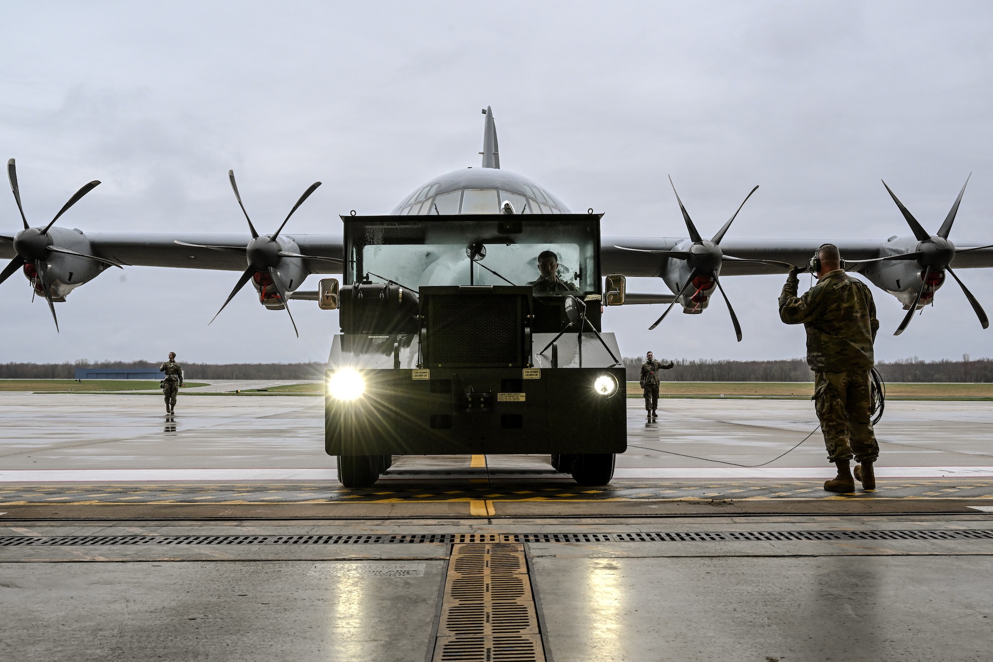 Citizen Airmen assigned to the 910th Maintenance Group assist in towing a C-130J-30 Super Hercules on the flightline at Youngstown Air Reserve Station, Ohio, April 6, 2025.