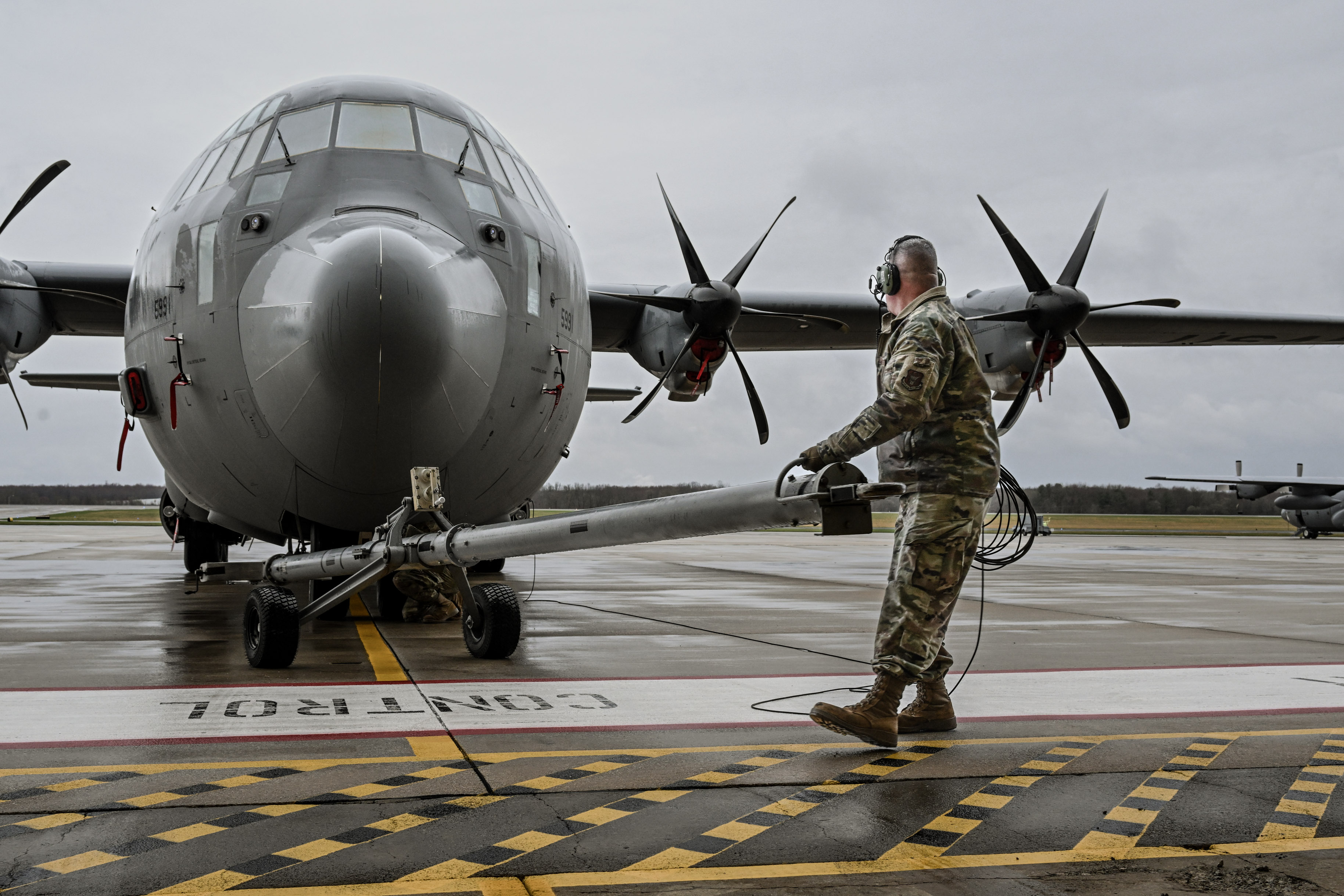 Master Sgt. Dan Scott, a dedicated crew chief, assists in towing a C-130J-30 Super Hercules on the flightline at Youngstown Air Reserve Station, Ohio, April 6, 2025.