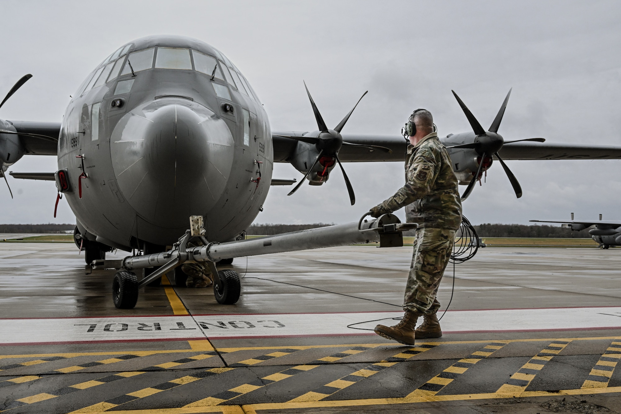 Master Sgt. Dan Scott, a dedicated crew chief, assists in towing a C-130J-30 Super Hercules on the flightline at Youngstown Air Reserve Station, Ohio, April 6, 2025.