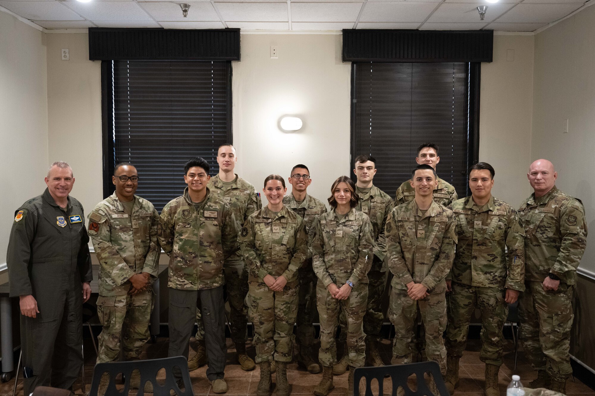 U.S. Air Force Maj. Gen. Charles Bolton, 18th Air Force commander, and Chief Master Sgt. Thomas Blount, 18th AF command chief, pose for a photo with Airmen assigned to the 317th Airlift Wing after an immersion visit breakfast at Dyess Air Force Base, Texas, April 2, 2025. The 18th AF command team spent the day meeting Airmen and touring various facilities to get a firsthand look at how the 317th AW is at the leading edge of tactical airlift. (U.S. Air Force photo by Airman Caleb Schellenberg)
