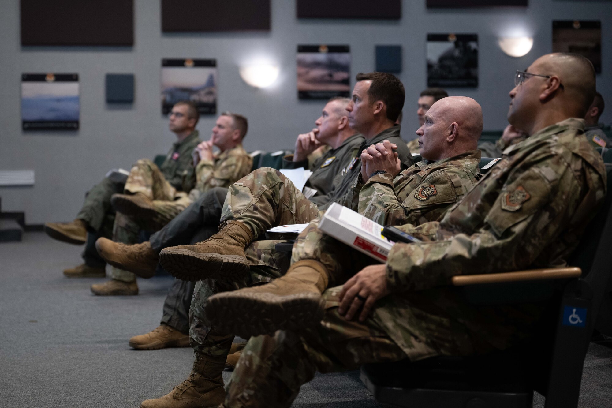 U.S. Air Force Maj. Gen. Charlie Bolton, 18th Air Force commander, and Chief Master Sgt. Thomas Blount, 18th AF command chief, attend a briefing alongside 317th Airlift Wing leadership at Dyess Air Force Base, Texas, April 2, 2025. The 18th AF command team spent the day meeting Airmen and touring various facilities across the installation to observe how the 317th AW is at the leading edge of tactical airlift. (U.S. Air Force photo by Airman Caleb Schellenberg)