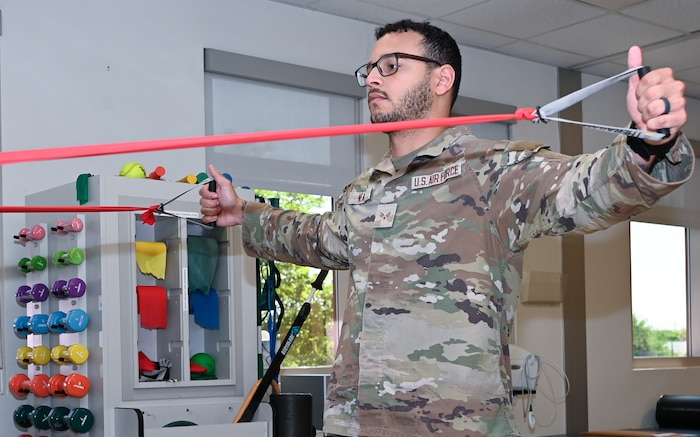 U.S. Air Force Senior Airman Christopher Neal, 42nd Medical Group physical medicine technician, demonstrates a strengthening exercise at Maxwell Air Force Base, Alabama, April 8, 2025.