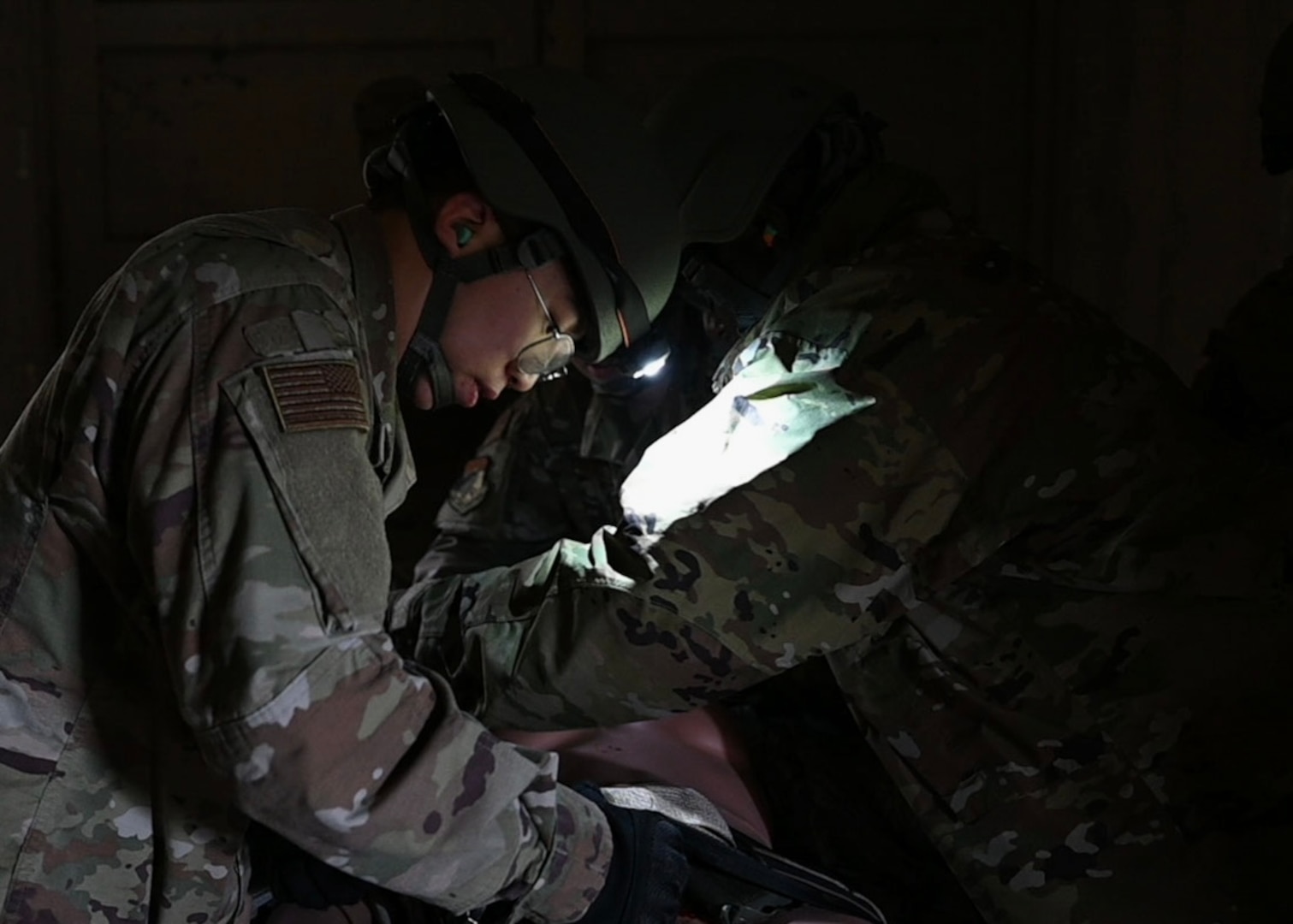 Airman practicing life-saving care on a mannequin.