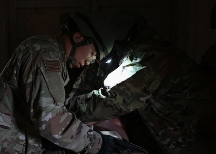 Airman practicing life-saving care on a mannequin.