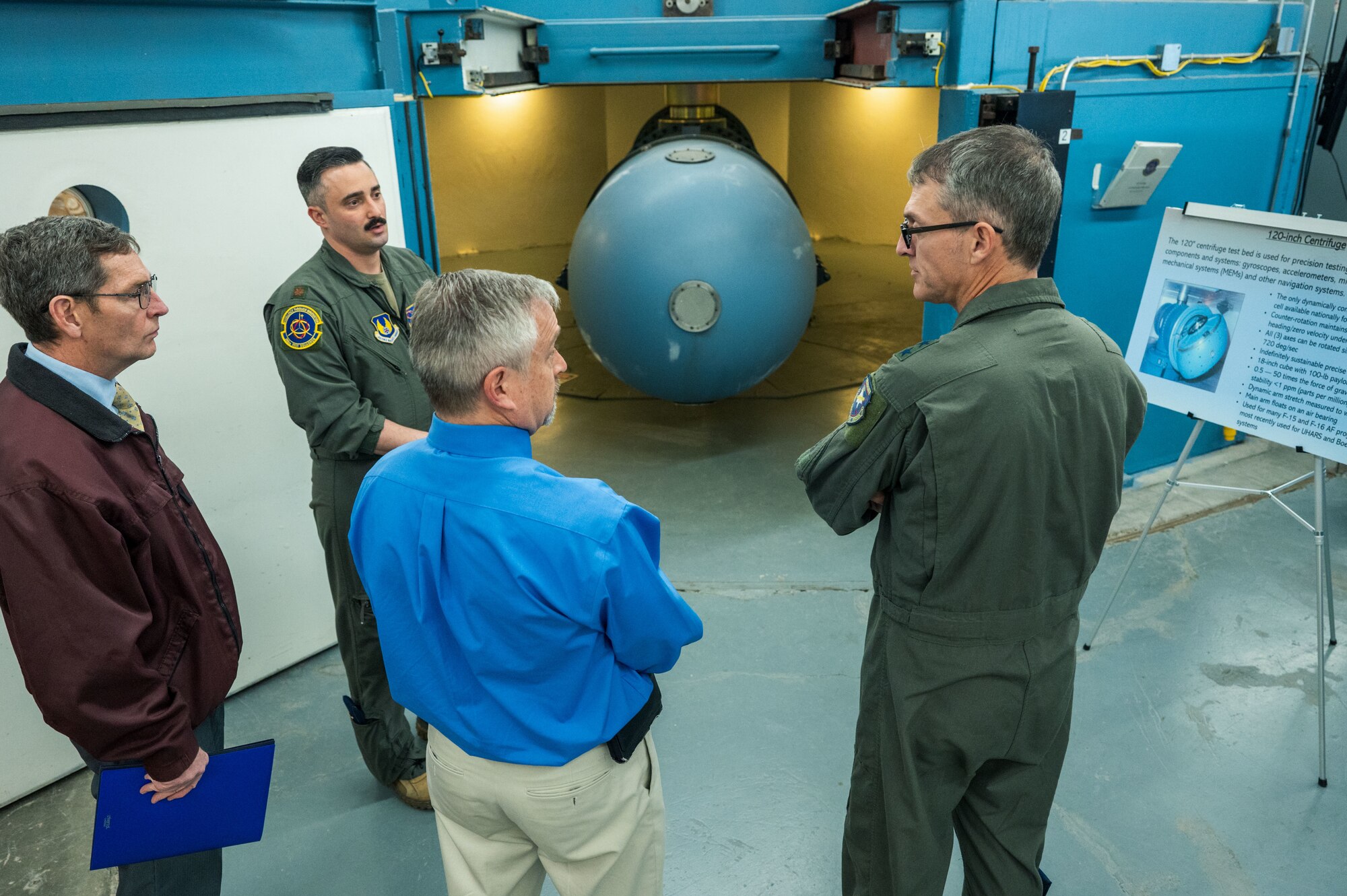 U.S. Air Force Maj. Gen. Scott Cain, Air Force Test Center commander, right, hears about the historic testing capabilities of the 120-inch centrifuge at Holloman Air Force Base, New Mexico, March 21, 2025. The 704th Test Group presented ideas to the general about improving test equipment, capabilities and facilities. (U.S. Air Force photo by Airman 1st Class Bob Teichmann)