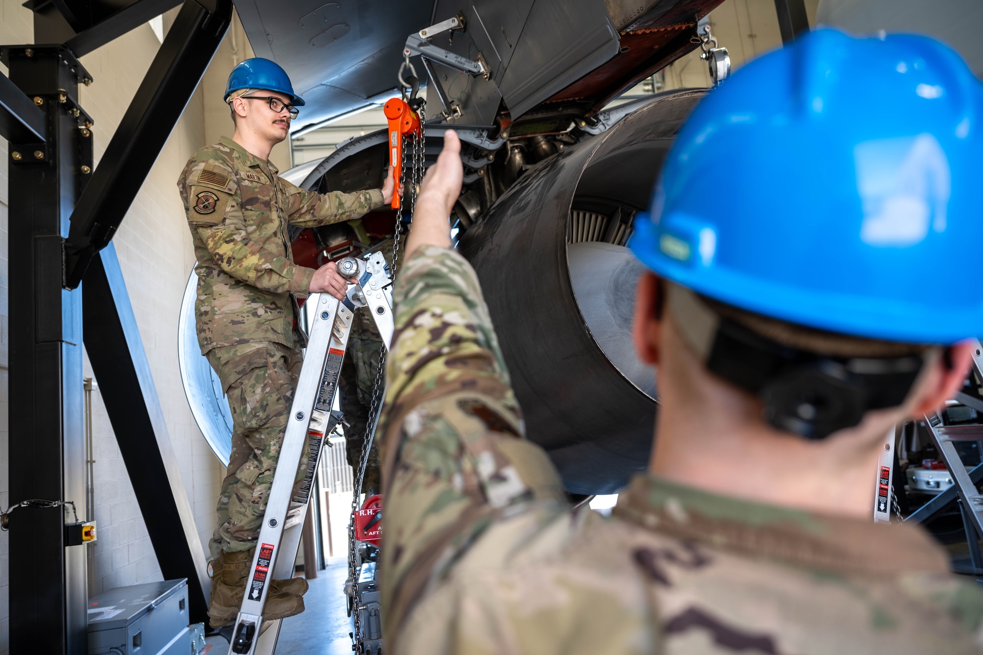 Tech. Sgt. Jason Belcher, 373rd Training Squadron Detachment 8 instructor, points out a part to be inspected by Senior Airman Dominic Petrone, 373rd TRS Detachment 8 student, at McConnell Air Force Base, Kansas, April 10, 2025.