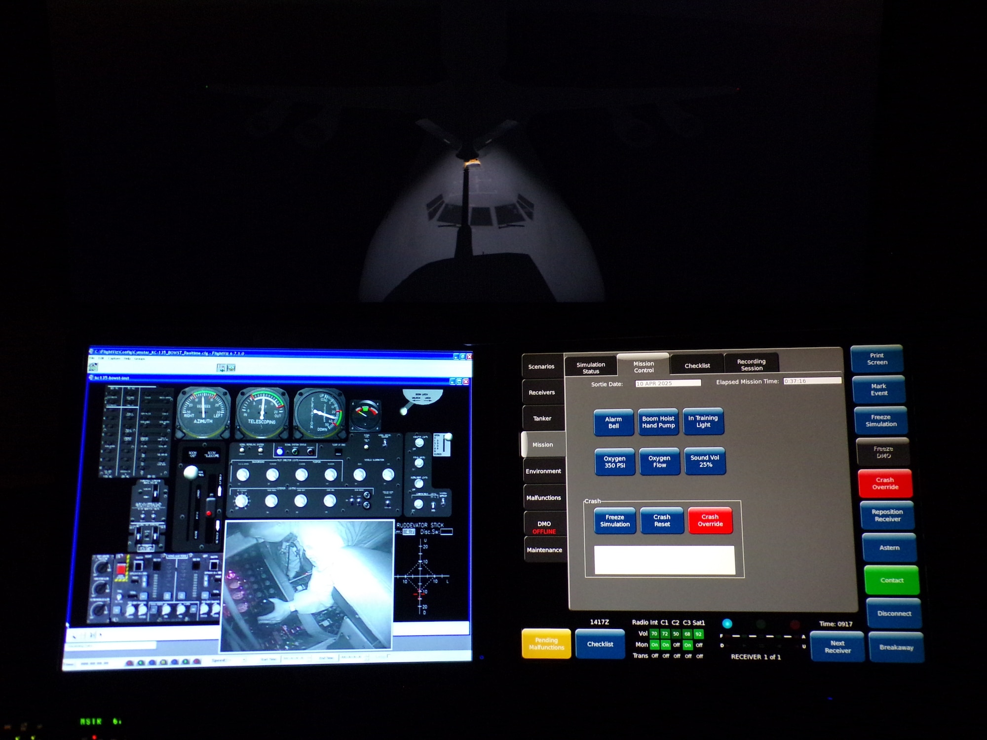 Three computer screens display various perspectives of the KC-135 boom refueling simulation, including visual tracking of a C-17, internal system controls, and mission parameters.