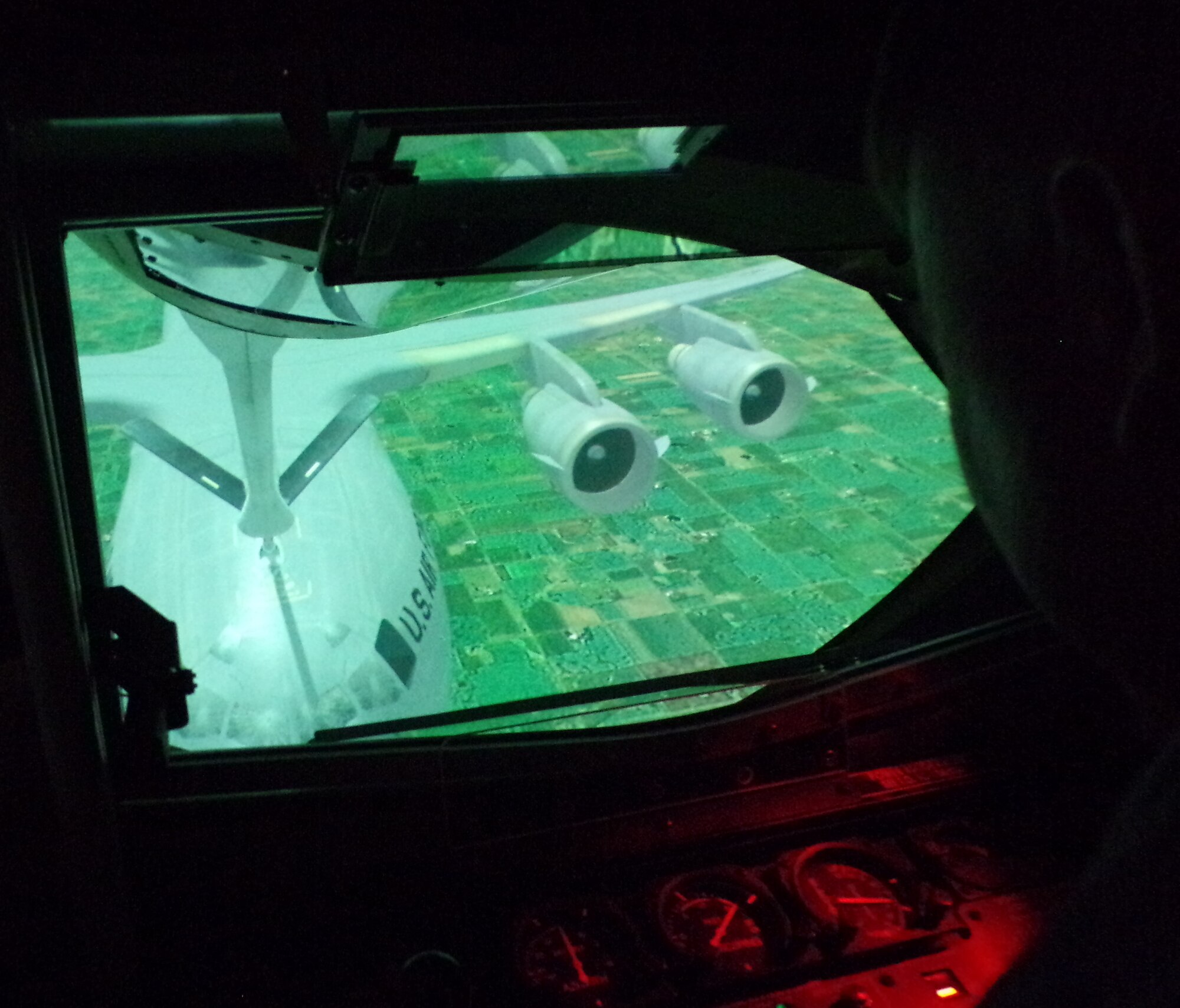 Col. John Poole, 375th Air Mobility Wing commander, aligns the refueling boom toward a simulated C-17 Globemaster III during training in the KC-135 Boom Pod Simulator.