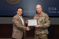 U.S. Air Force Maj. Gen. Carey, chief of staff for U.S. Indo-Pacific Command, is presented with a memento from the National Defense University Foreign Fellows during their capstone event at USINDOPACOM headquarters on Camp H.M. Smith, Honolulu, April 10, 2025.