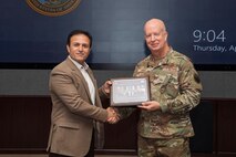 U.S. Air Force Maj. Gen. Carey, chief of staff for U.S. Indo-Pacific Command, is presented with a memento from the National Defense University Foreign Fellows during their capstone event at USINDOPACOM headquarters on Camp H.M. Smith, Honolulu, April 10, 2025.