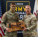Command Sgt. Maj. Michael Kelly, Illinois Army National Guard State Command Sergeant Major, presents Spc. Nathan Johnson with the Soldier of the Year award at the Illinois Army National Guard’s Best Warrior Competition, April 4-6.