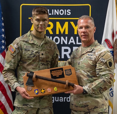Command Sgt. Maj. Michael Kelly, Illinois Army National Guard State Command Sergeant Major, presents Spc. Nathan Johnson with the Soldier of the Year award at the Illinois Army National Guard’s Best Warrior Competition, April 4-6.