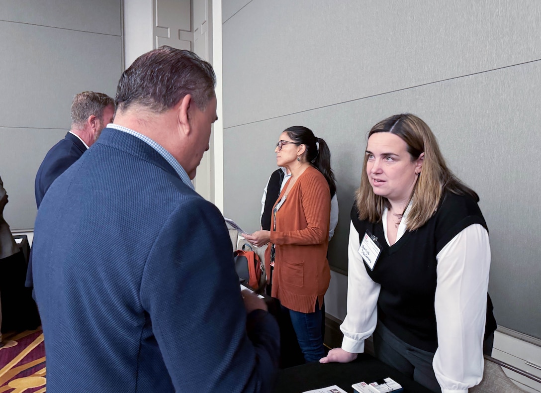 U.S. Army Corps of Engineers Sacramento District team member, Kristine DesChamps speaks with an attendee  at the annual Business Opportunity Open House hosted by the small business section at the Hyatt Regency in Sacramento, California on March 12, 2025. (U.S. Army photo by Bertha Smith, U.S. Army Corps of Engineers Sacramento District Public Affairs)
