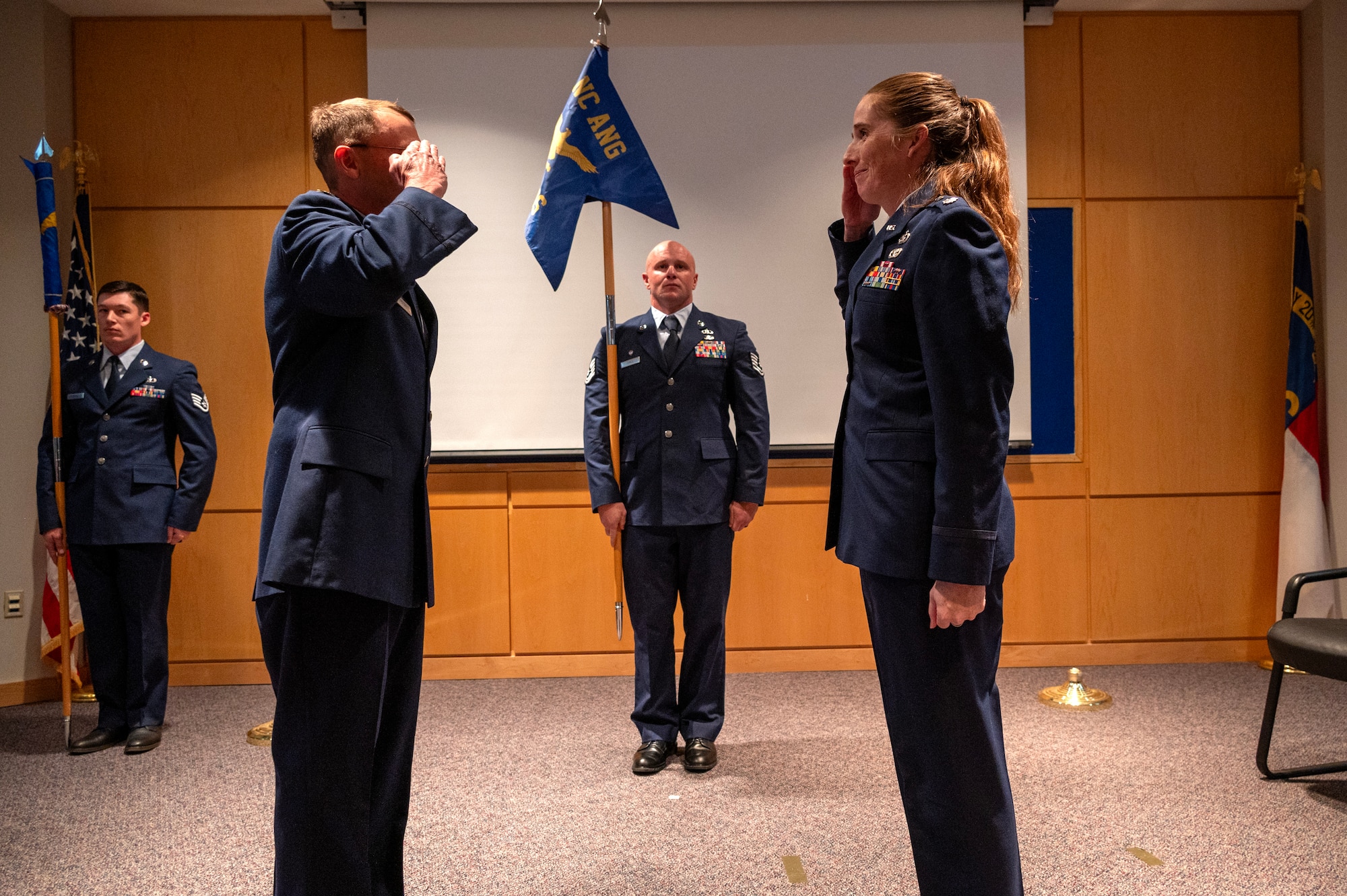 U.S. Air Force Col. Michael S. Lineberger, 145th Operations Group commander, left, and Lt. Col. Erin M. Root, 235th Combat Airfield Operations Squadron (235 CAOS) commander, right, render salutes at the 235 CAOS redesignation ceremony at the North Carolina Air National Guard’s New London, N.C. location, March 7, 2025.
