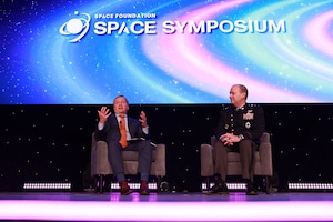 Two men sitting next to each other in chairs during interview