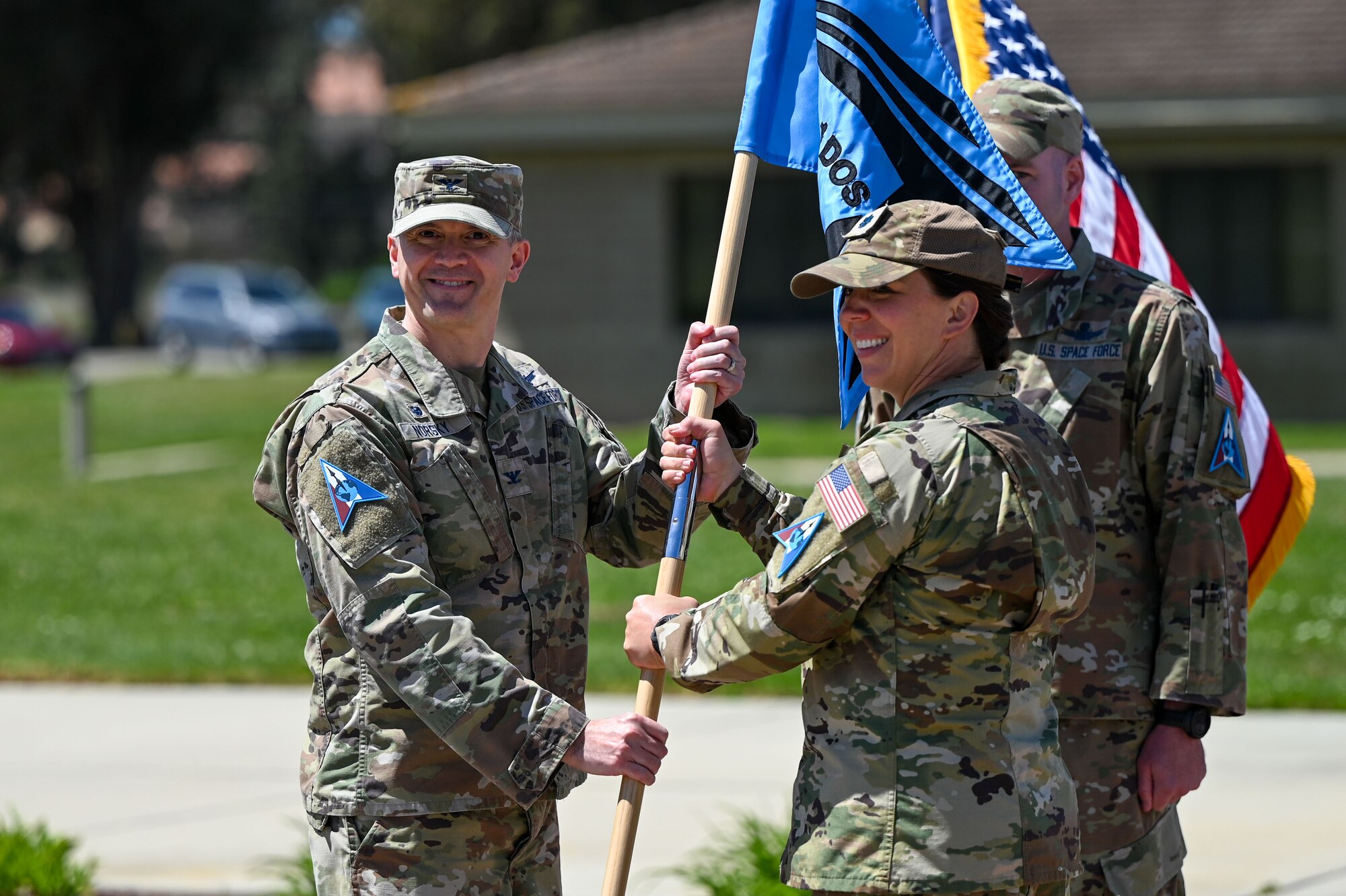 People hold a flag outside.