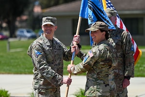 People hold a flag outside.