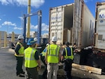U.S. Coast Guardsmen assigned to Coast Guard Sector Honolulu, U.S. Customs and Border Protection personnel, and Hazardous Materials Safety Administration personnel inspect a shipping container at the Port of Honolulu April 9, 2025. Coast Guard personnel led a Multi-Agency Strike Force Operation (MASFO) at the Port of Honolulu’s container terminal, inspecting 56 containers and checking 155 Transportation Worker Identification Credentials. (U.S. Coast Guard photo, courtesy Sector Honolulu)