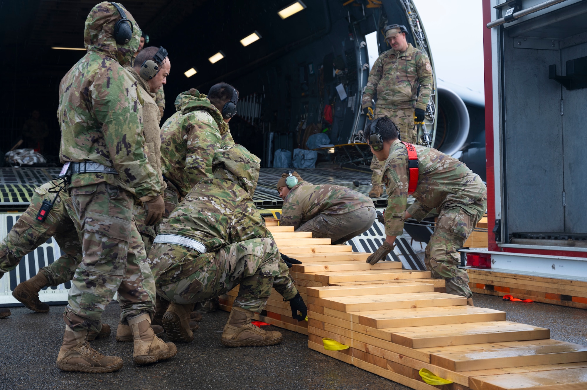 U.S. Air Force Airmen with the 62d Aerial Port Squadron, 446th APS and 709th Airlift Squadron from Dover Air Force Base, Delaware, load a fire truck onto a C-5M Super Galaxy at Joint Base Lewis-McChord, Washington, April 8, 2025. 
A donated fire truck arrived at JBLM via flatbed truck to be shipped to Guatemala in support of the Denton Humanitarian Assistance Program.