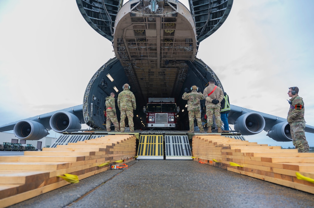 U.S. Air Force Airmen with the 62d Aerial Port Squadron, 446th APS and 709th Airlift Squadron from Dover Air Force Base, Delaware, load a fire truck onto a C-5M Super Galaxy at Joint Base Lewis-McChord, Washington, April 8, 2025. 
A donated fire truck arrived at JBLM via flatbed truck to be shipped to Guatemala in support of the Denton Humanitarian Assistance Program.