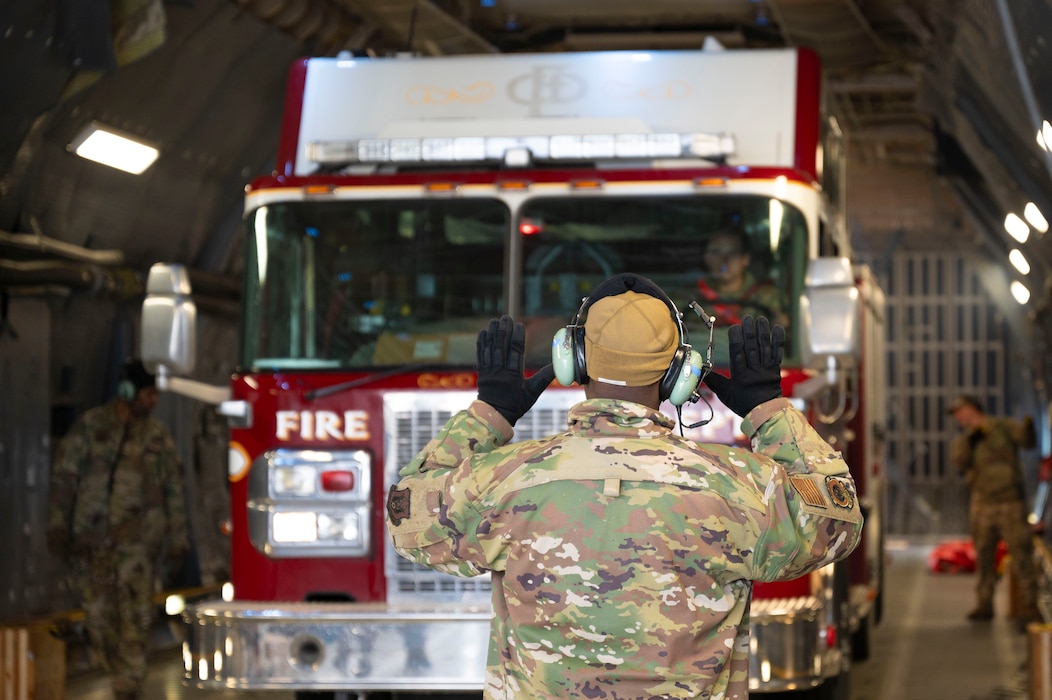 U.S. Air Force Airmen with the 62d Aerial Port Squadron, 446th APS and 709th Airlift Squadron from Dover Air Force Base, Delaware, load a fire truck onto a C-5M Super Galaxy at Joint Base Lewis-McChord, Washington, April 8, 2025. 
A donated fire truck arrived at JBLM via flatbed truck to be shipped to Guatemala in support of the Denton Humanitarian Assistance Program.