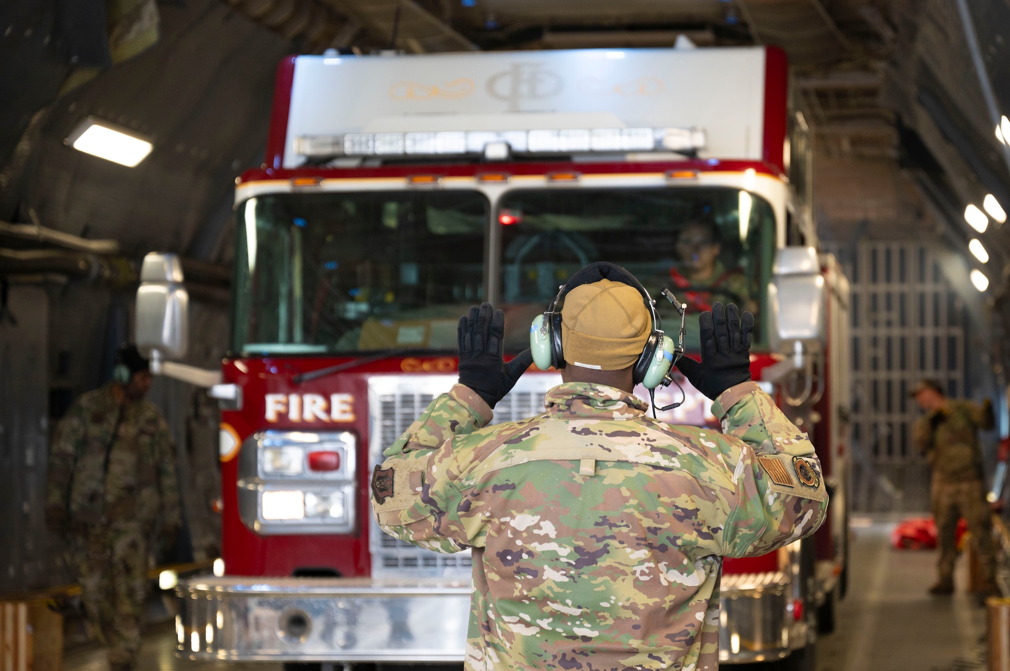 U.S. Air Force Airmen with the 62d Aerial Port Squadron, 446th APS and 709th Airlift Squadron from Dover Air Force Base, Delaware, load a fire truck onto a C-5M Super Galaxy at Joint Base Lewis-McChord, Washington, April 8, 2025. 
A donated fire truck arrived at JBLM via flatbed truck to be shipped to Guatemala in support of the Denton Humanitarian Assistance Program.