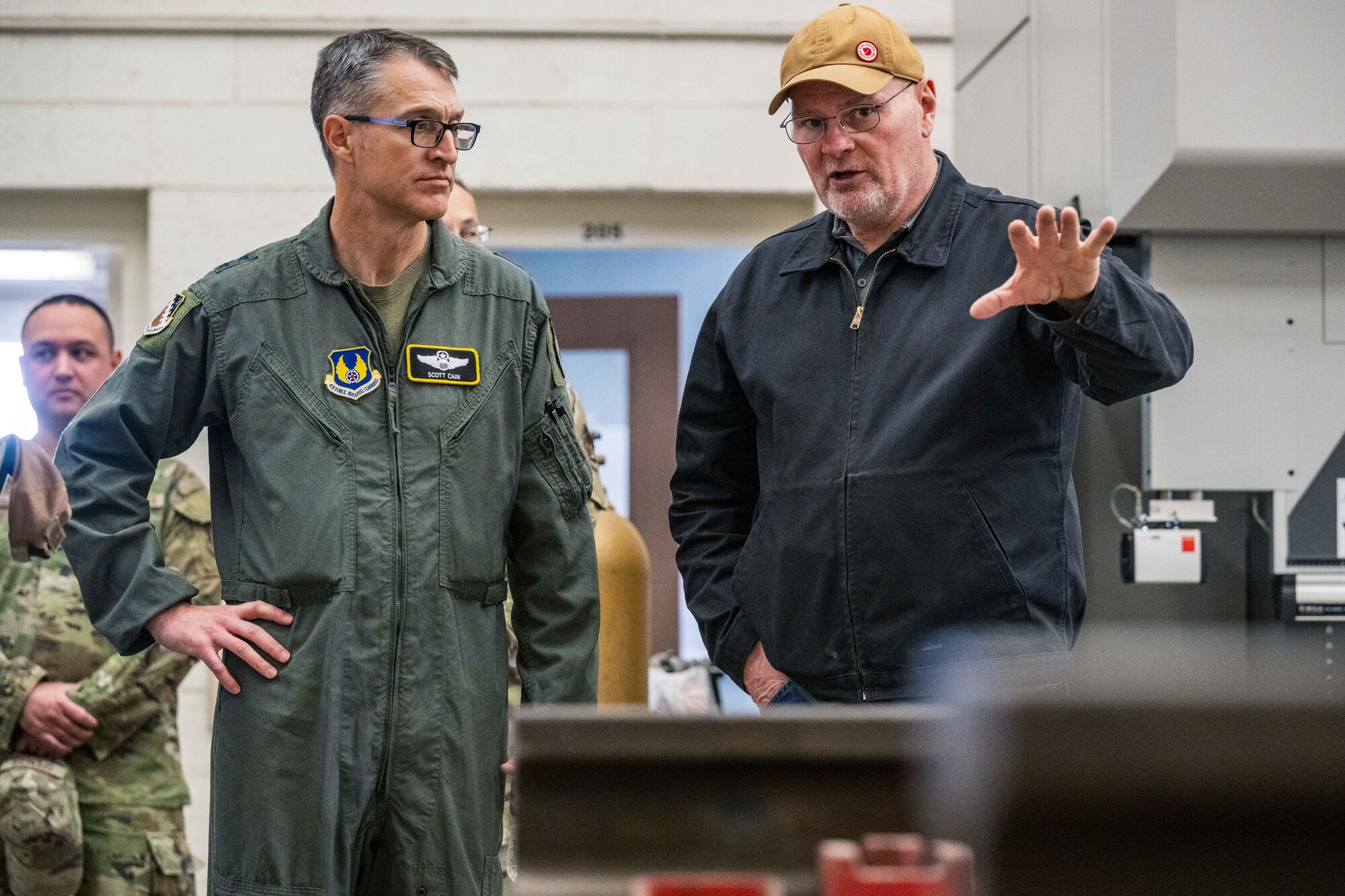 U.S. Air Force Maj. Gen. Scott Cain, Air Force Test Center commander, left, listens to suggestions about revitalizing the Holloman High Speed Test Track from Thomas Kanios, 846th Test Squadron fabrication shop supervisor, at Holloman Air Force Base, New Mexico, March 21, 2025. The HHSTT has been regularly upgraded and repaired for more than 75 years to keep it on the leading edge of testing capabilities. (U.S. Air Force photo by Airman 1st Class Bob Teichmann)