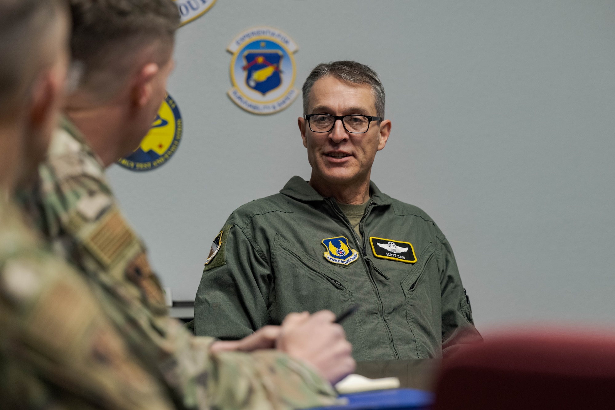 U.S. Air Force Maj. Gen. Scott Cain, Air Force Test Center commander, right, meets with members of the 704th Test Group at Holloman Air Force Base, New Mexico, March 21, 2025. Cain met with representatives of various departments to discuss ways to improve current equipment and infrastructure. (U.S. Air Force photo by Airman 1st Class Bob Teichmann)