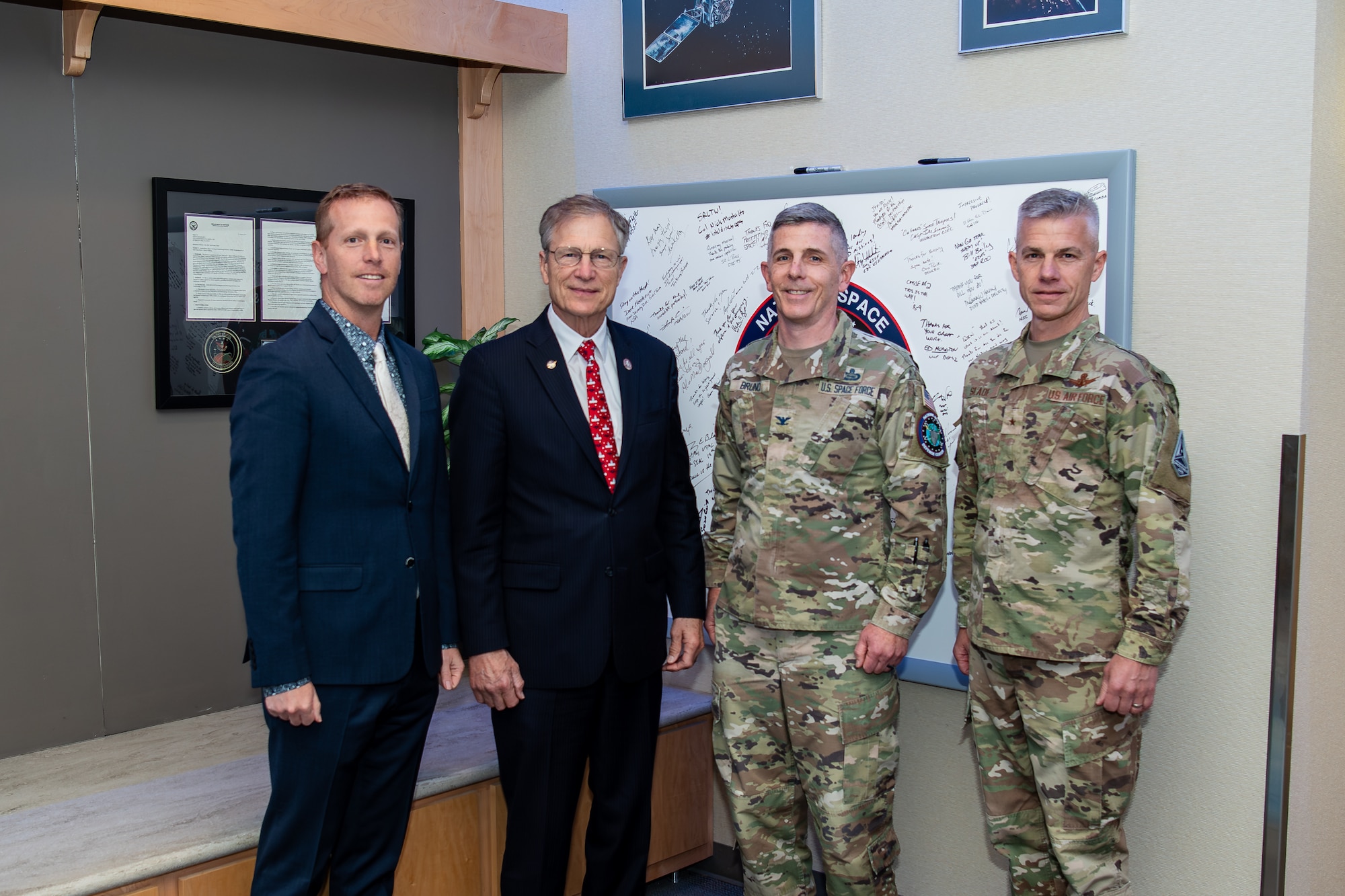 four men pose for group photo